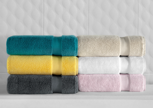Soft white SaaSoh Klassic Collection bath towel folded on a neutral background, showcasing plush texture and quality fabric.