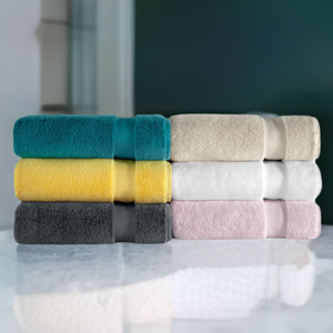 Soft white SaaSoh Klassic Collection bath towel with textured design, shown folded on a clean white background.