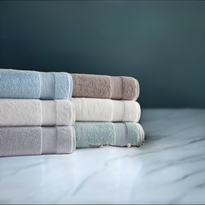 Silver collection bath towels from SaaSoh, soft and plush fabric, neatly folded with a luxurious silver finish.