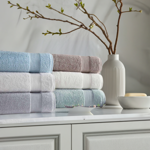 Silver Collection bath towels by SaaSoh, showing soft, plush silver-colored fabric with a textured pattern.