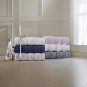 Soft white SaaSoh Apogee Collection luxury bath towel folded neatly, showcasing plush texture and elegant design.