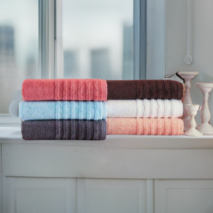 Soft white SaaSoh Opulent Collection bath towels stacked neatly, showcasing plush, luxurious texture and high-quality fabric.
