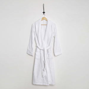 White Aspen Collection bathrobe by SaaSoh, soft and cozy with a plush fabric, displayed on a hanger.