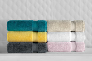 Soft white SaaSoh Klassic Collection bath towels displayed, showcasing plush, absorbent fabric and elegant design.