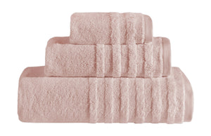 Soft coral and shell-colored bath towels from SaaSoh Opulent Collection, three-piece set displayed on a bathroom rack.
