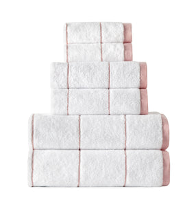 Soft Salmon-colored SaaSoh Raya Collection bath towel displayed on a bathroom hook, showcasing plush fabric and elegant design.
