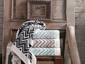 Bath towel from SaaSoh's Santorini Collection featuring vibrant blue and white striped pattern, soft and plush texture.