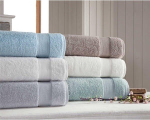 Soft silver bath towels from SaaSoh Silver Collection, neatly folded and displayed in a luxurious bathroom setting.